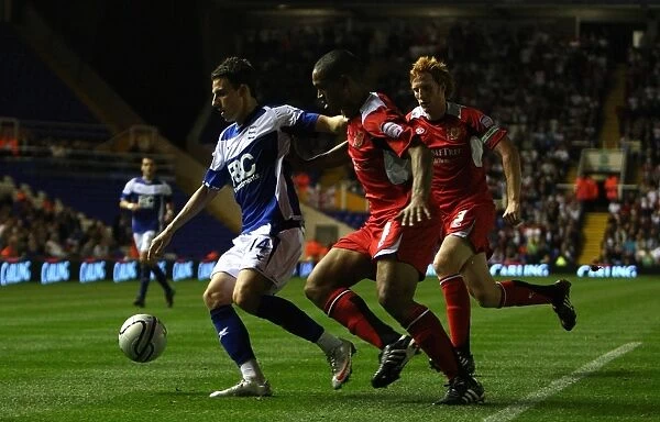 Birmingham City's Matt Derbyshire Stands Firm Against Milton Keynes Dons Doumbe and Lewington in Carling Cup Showdown