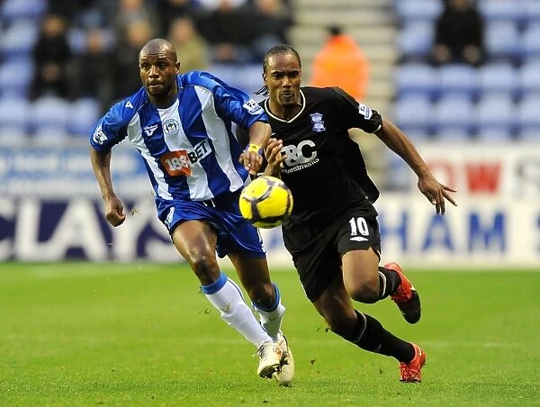 Intense Battle for Ball Possession: Birmingham City vs. Wigan Athletic (05-12-2009, DW Stadium)