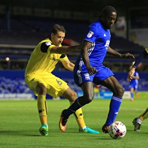 Clash at St. Andrews: Birmingham City's Donaldson Fights for Possession against Oxford United