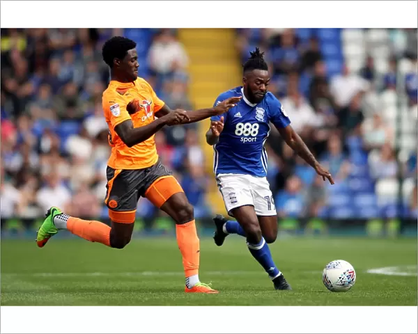 Birmingham City vs. Reading: Intense Battle for the Ball between Jacques Maghoma and Tyler Blackett