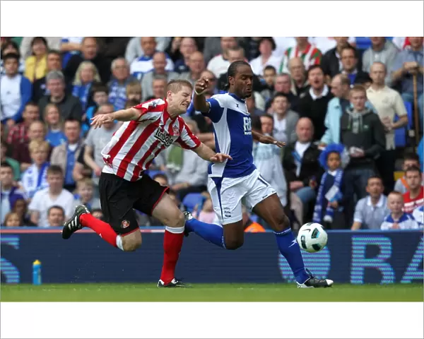 Intense Rivalry: Jerome vs. Turner's Battle for Ball Possession (BPL, Birmingham City vs. Sunderland, 16-04-2011)