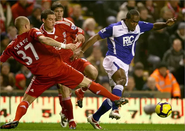 Intense Rivalry: Skrtel, Agger vs. Jerome - Liverpool vs. Birmingham City's Fierce Battle for the Ball (09-11-2009, Anfield)