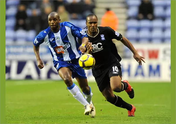 Intense Battle for Ball Possession: Birmingham City vs. Wigan Athletic (05-12-2009, DW Stadium)