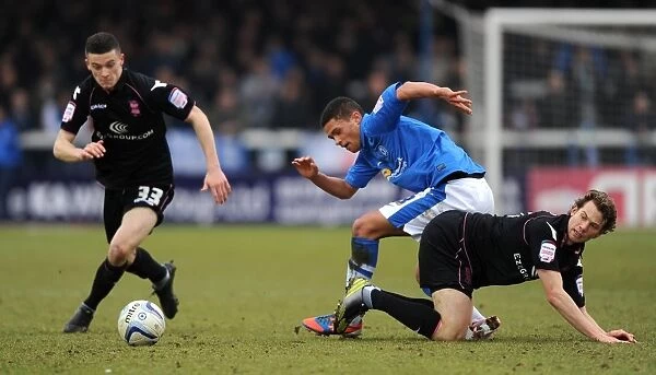 Battling for the Ball: Ferdinand, Reilly, and Spector in the Intense Championship Clash between Peterborough United and Birmingham City (February 2013)