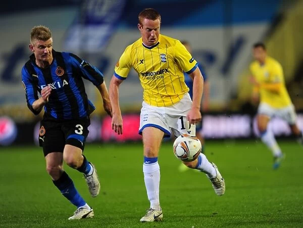 Battling for Control: Almeback vs. Rooney in UEFA Europa League Showdown between Club Brugge and Birmingham City (October 2011)