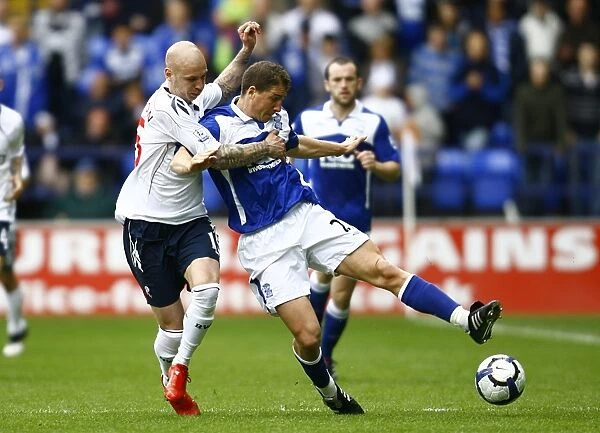 Battling for Supremacy: Gretar Rafn Steinsson vs. Gregory Vignal in the Barclays Premier League Clash between Birmingham City and Bolton Wanderers (09-05-2010, Reebok Stadium)