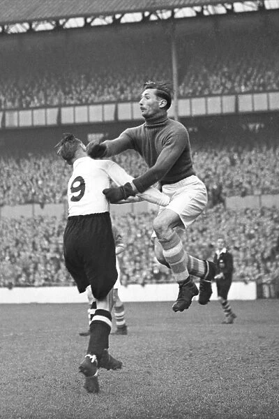 Birmingham City's Gil Merrick Fends Off Tottenham Hotspur's Pressure in Football League Division Two Clash: A Vintage Action Image