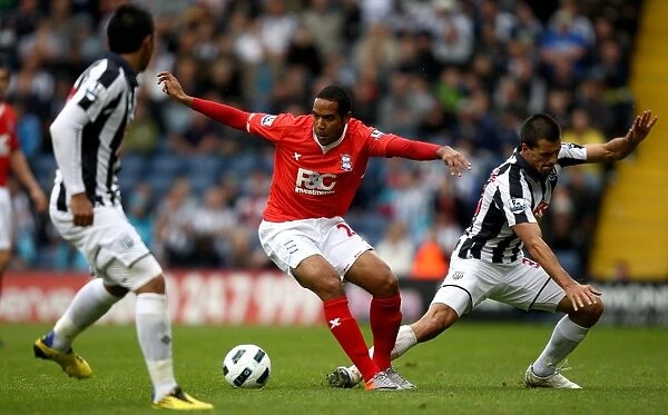 Birmingham City's Jean Beausejour Dodges Paul Scharner's Challenge: A Moment from the BPL Clash at The Hawthorns (2010)