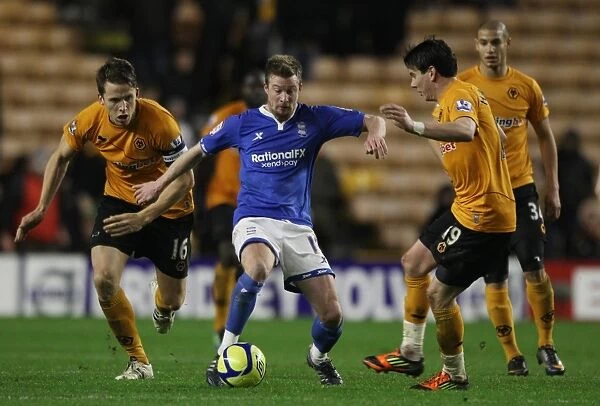 Birmingham City's Wade Elliott Battles Past Wolves Defenders Berra and Hammill in FA Cup Third Round Replay