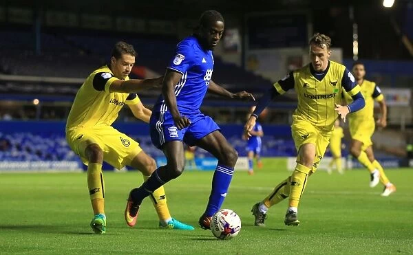 Clash at St. Andrews: Birmingham City's Donaldson Fights for Possession against Oxford United