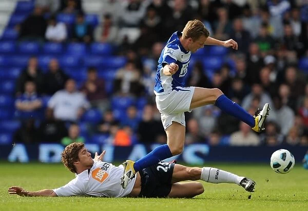 Clash of Titans: Larsson vs. Alonso in the Premier League Showdown between Birmingham City and Bolton Wanderers (02-04-2011)