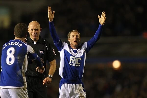 Controversial Confrontation: Gardner and Bowyer Argue with Referee Howard Webb (Birmingham City vs. West Ham United, Carling Cup Semi-Final)