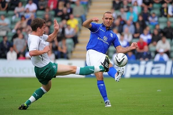 David Murray vs Luke Young: A Battle for the Ball in Pre-Season Friendly between Plymouth Argyle and Birmingham City