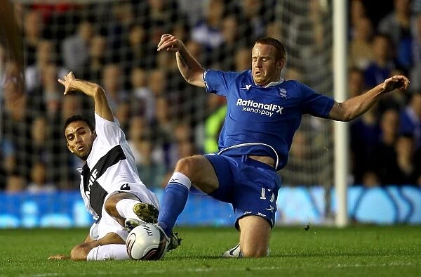 Intense Battle for Ball Possession: Birmingham City vs. Nacional - Ferreira Danielson vs. Adam Rooney (UEFA Europa League Play-Off, 2011)