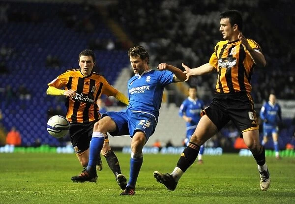 Intense Battle for Control: Spector Sandwiched Between Evans and Hobbs - Birmingham City vs Hull City (Npower Football League Championship, 14-02-2012)