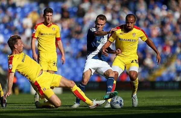 Intense Battle for Possession: Maikel Kieftenbeld of Birmingham City Faces Off Against Rotherham United's Vadis Odjidja-Ofeo and Danny Collins
