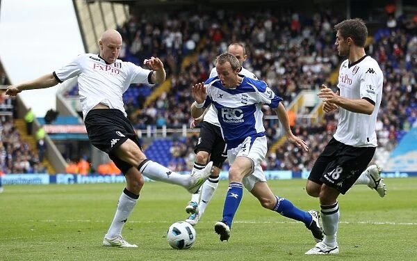 Intense Rivalry: Bowyer vs. Hughes Battle for Ball at St. Andrew's (Birmingham City vs. Fulham, Premier League, 15-05-2011)