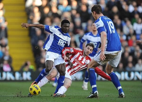Intense Rivalry: Delap vs. Martins Battle for Ball in Birmingham City vs Stoke City (Barclays Premier League, St. Andrew's)