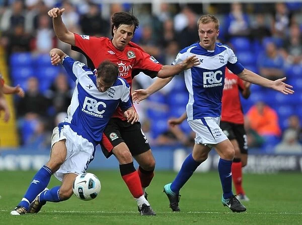Intense Rivalry: Johnson, Larsson, and Kalinic's Battle for Ball Possession (2010) - Birmingham City vs. Blackburn Rovers