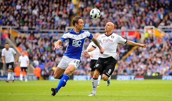 Intense Rivalry: Johnson vs Jiranek's Battle for Ball Possession (Birmingham City vs Fulham, Premier League, St. Andrew's, 15-05-2011)
