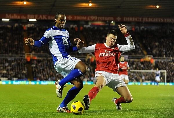 Intense Rivalry: Koscielny vs. Jerome's Battle for Ball Possession (Birmingham City vs. Arsenal, Premier League, St. Andrew's, 01-01-2011)