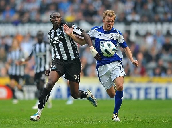 Intense Rivalry: Larsson vs. Ameobi Battle for Ball in Birmingham City vs. Newcastle United (Barclays Premier League, St. James Park, 07-05-2011)