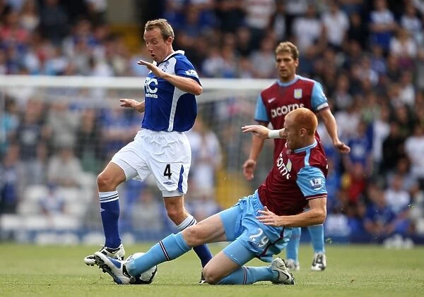 Intense Rivalry: Lee Bowyer vs. James Collins Battle for the Ball - Birmingham City vs. Aston Villa (September 13, 2009, St. Andrew's)