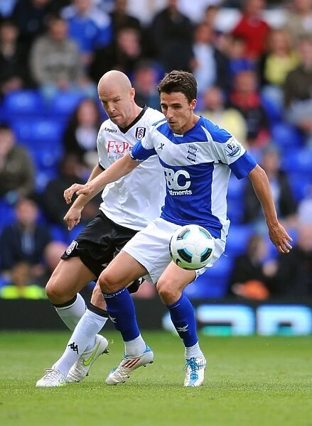 Intense Rivalry: Senderos vs. Derbyshire - A Battle for Ball Possession (Birmingham City vs. Fulham, Premier League, 15-05-2011)