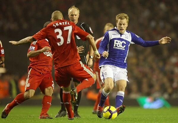 Intense Rivalry: Skrtel vs. Larsson Battle for the Ball - Liverpool vs. Birmingham City, Premier League (09-11-2009, Anfield)