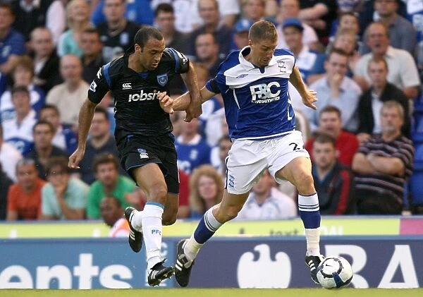 Intense Rivalry: Vanden Borre vs. Vignal's Battle for Ball Possession - Birmingham City vs. Portsmouth (Premier League, 19-08-2009)