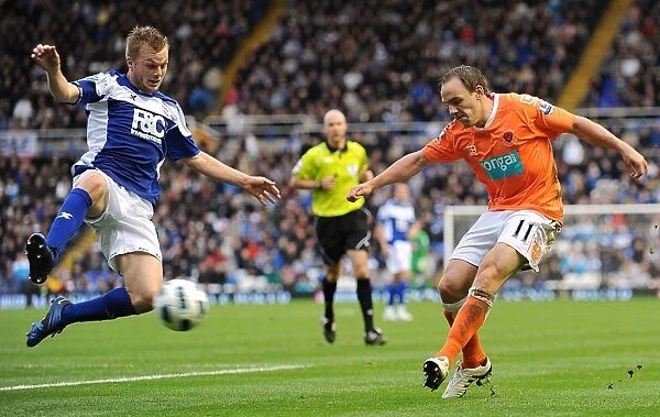 Larsson Chases Down Vaughan's Cross: Intense Premier League Rivalry between Birmingham City and Blackpool (23-10-2010)