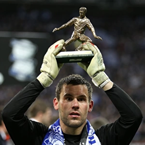 Birmingham City goalkeeper Ben Foster celebrates with his man of the match trophy