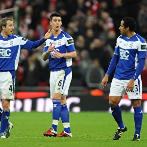 Deep in Thought: Bowyer, Ridgewell, and Beausejour's Intense Discussion during Birmingham City's Carling Cup Final against Arsenal at Wembley Stadium