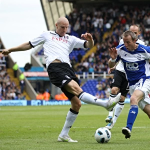 Intense Rivalry: Bowyer vs. Hughes Battle for Ball at St. Andrew's (Birmingham City vs. Fulham, Premier League, 15-05-2011)
