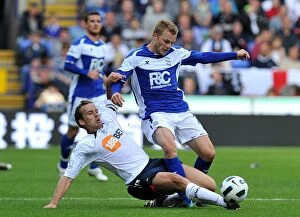 Images Dated 29th August 2010: Battling for Control: Davies vs. Larsson in the Premier League Showdown at Reebok Stadium