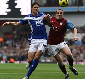 Images Dated 31st October 2010: Battling for Supremacy: Zigic vs. Dunne - The Intense Rivalry in the Birmingham Derby, Villa Park