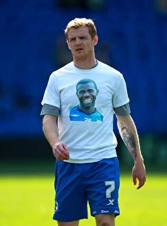 25-03-2012 v Cardiff City, St. Andrew's Collection: Birmingham City's Chris Burke Pays Tribute to Ill Fabrice Muamba with Shirt Message
