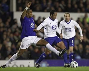 09-03-2011 v Everton, Goodison Park Collection: Distin vs. Beausejour: A Battle of Intense Action in Everton vs