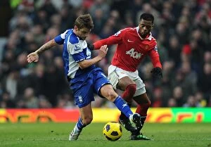 22-01-2011 v Manchester United, Old Trafford Collection: Evra vs Bentley: A Premier League Showdown - Intense Battle for Ball Possession (22-01-2011)