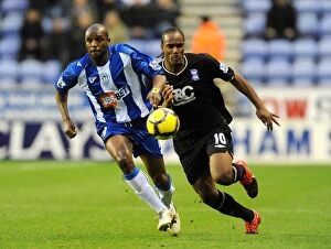Images Dated 5th December 2009: Intense Battle for Ball Possession: Birmingham City vs. Wigan Athletic (05-12-2009, DW Stadium)