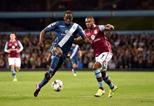 Images Dated 22nd September 2015: Intense Rivalry: Bacuna vs. Donaldson - Battle for the Ball in Capital One Cup Clash at Villa Park