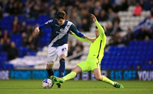 Intense Rivalry: Battle for the Ball between Birmingham City's Kyle Lafferty and Brighton & Hove Albion's Dale Stephens