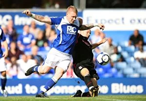 Images Dated 22nd August 2009: Intense Rivalry: Garry O'Connor vs Andy Wilkinson - Battle for Ball Possession in Birmingham City