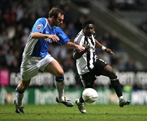 FA Cup Round 3 Replay, 17-01-2007 v Newcastle United, St. James' Park Collection: Intense Rivalry: Martins vs. Taylor's Battle for the Ball in FA Cup Third Round Replay between