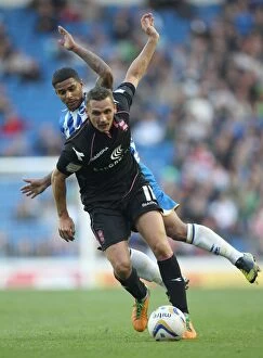 Images Dated 29th September 2012: Lovenkrands vs. Bridcutt: Intense Championship Tackle at AMEX Stadium